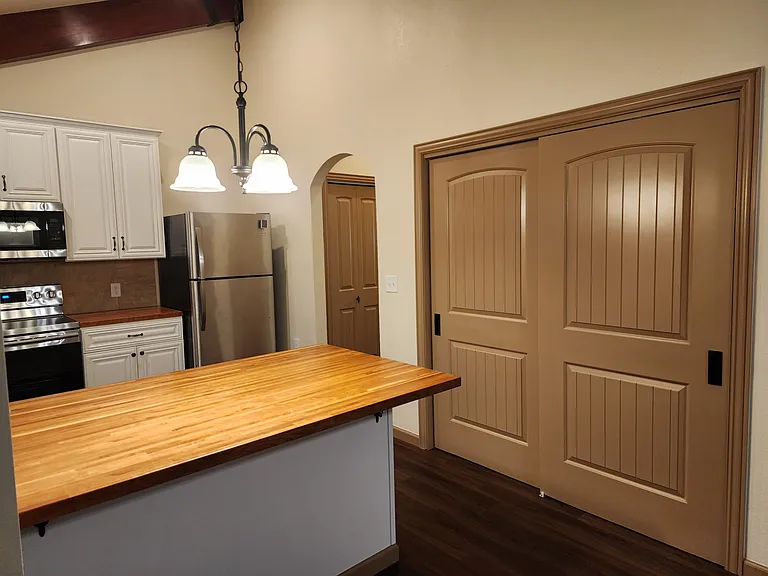 Pantry, door through arch way is the laundry room.