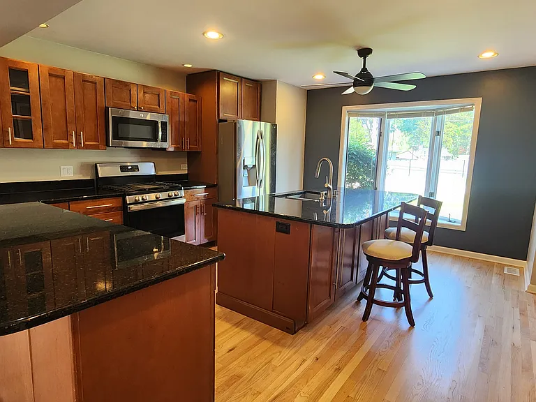 Kitchen with granite countertops and stainless steel appliances including a "smart fridge" that is WiFi enabled.