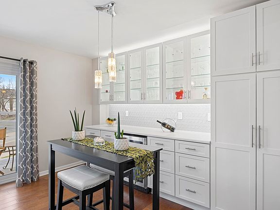Dining Room with lighted upper cabinets and wine refrigerator