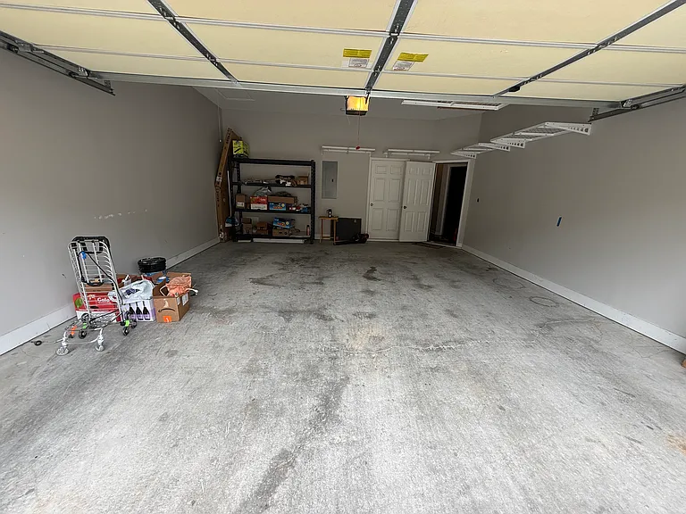 Large two car garage with plenty of rack and overhead storage.