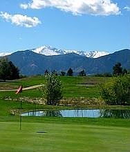 View of adjacent tee box and green behind house