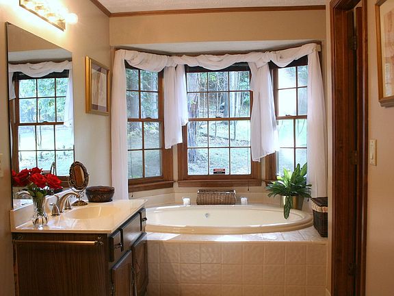 master bath with large jetted tub and seperate vanities