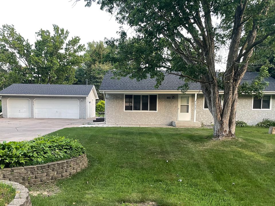 Rambler home with large garage and concrete driveway.