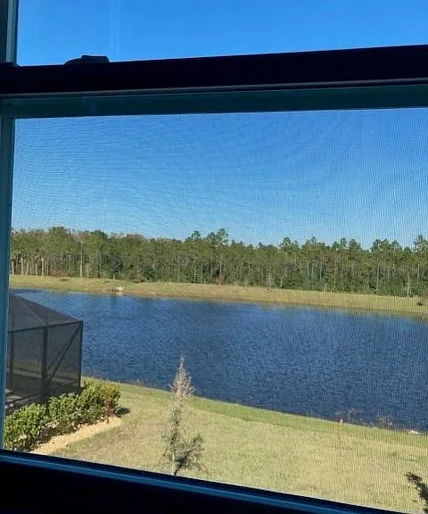 View of nature and water feature behind house