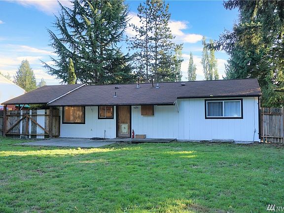 Big back yard is fully fenced, has patio & outbuilding w/power.