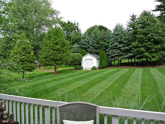 Our backyard showing deck and shed