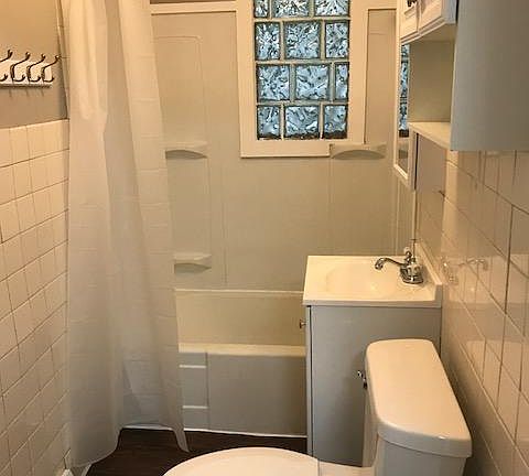 New sink, mirror, cabinets, toilets, shower curtain and pain