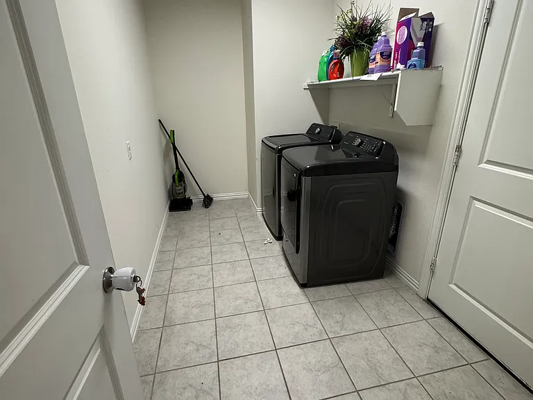 Spacious laundry room with space for storage.