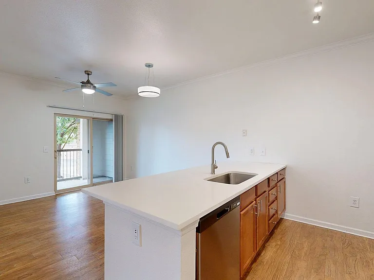 Apartment Kitchen with Stainless Steel Appliances, Dining and Living Room withwood-style floors and Patio/Balcony.