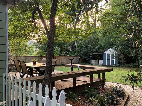 Fenced backyard offers privacy, deck, and rear entrance to laundry room / bedroom 3.