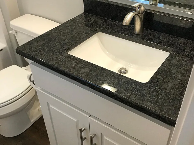 2nd Floor rear bedroom bathroom. All tops are granite and faucets are brushed nickel.