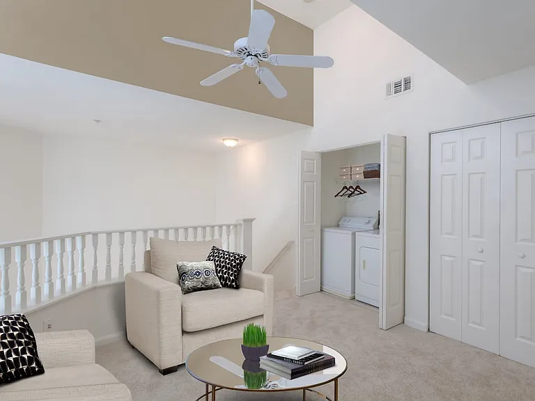 Loft with in-unit washer and dryer and carpeted flooring