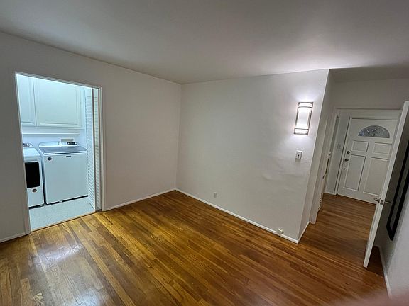 Bedroom showing front door and laundry door open