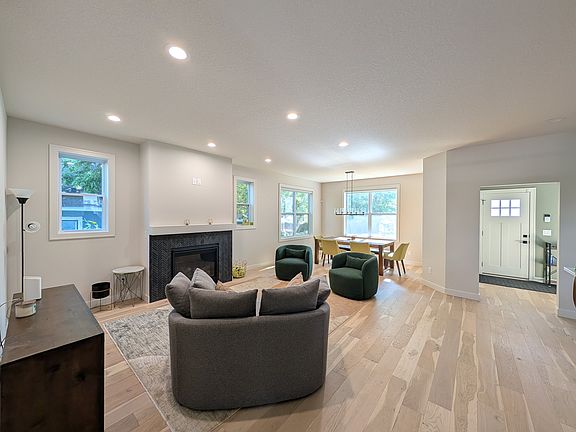 Dining and living with gas fireplace. Lots of natural light!