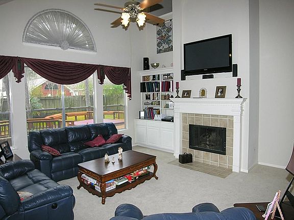 Family Room with Gas Log Fireplace, Built-In Entertainment Center, New Freize Carpet and Great Views.