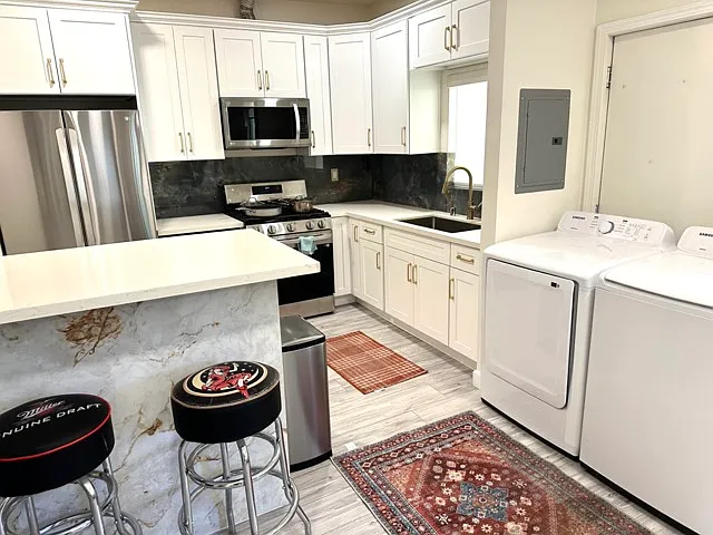 Kitchen with appliances, and bar table with tons of cabinet space.