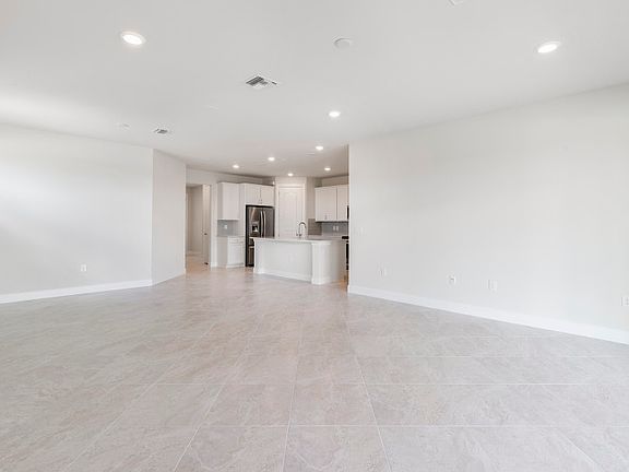 Spacious gathering room with porcelain tile flooring and LED lighting, great for entertaining