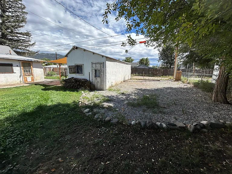 Behold: the garage (storage-only, no cars please) and the mighty gravel pad_perfect for your trailer, camper, or spaceship. Plenty of room for adventure gear, questionable hobbies, or future road trips on wheels!