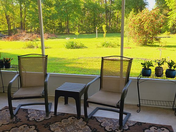 screened porch sitting area with view of backyard