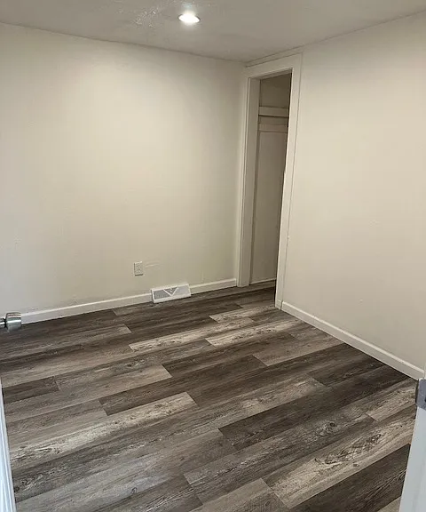 Bedroom with Window (not shown) and small closet. Brand New Floor.