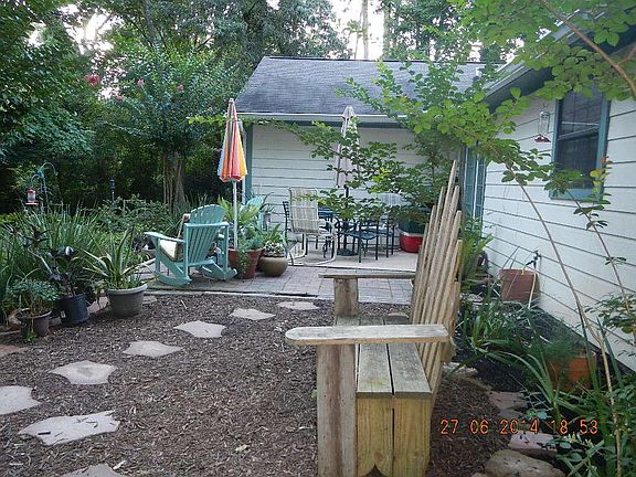CLOSE UP OF THE MANY SITTING AREAS AT THE BACK OF THE HOME