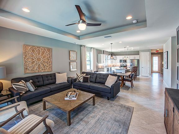 Model Representation Open concept gathering room with porcelain tile floors