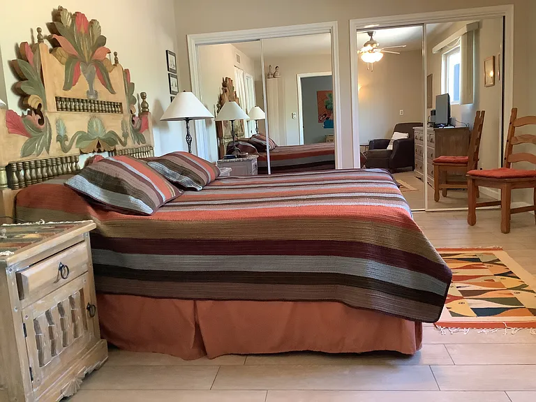 King bed and small tv in bedroom. Great built-in storage and ensuite bathroom.