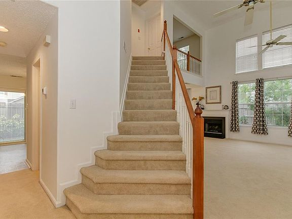Sweeping staircase overlooking the spectacular open living room.