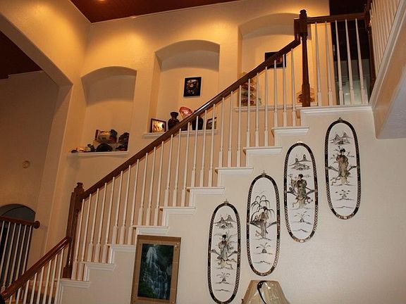 Stairway across entry way with arched niches in wall