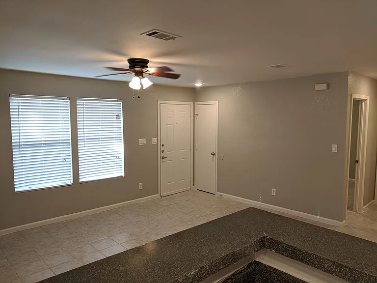 View of open living/dining areas from kitchen. New 2-inch window blinds
