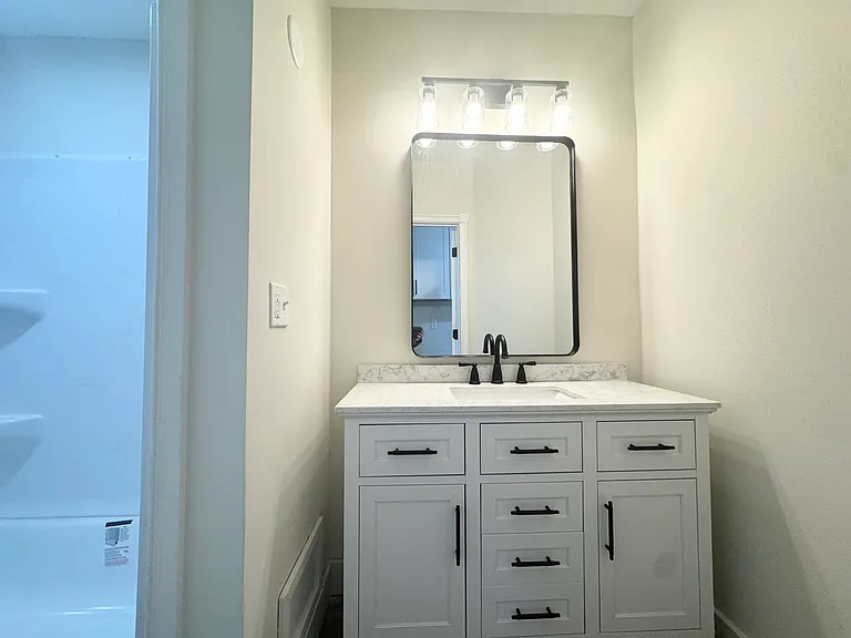 Bathroom has new vanity with quartz countertops