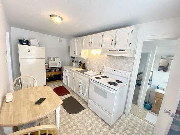 A galley style kitchen that fits a nice sized table and has tons of natural light!