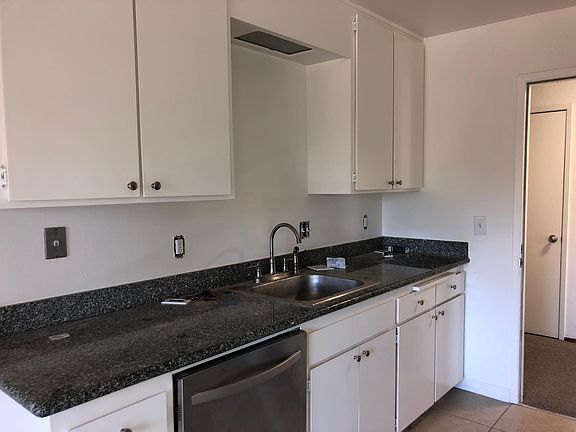 Kitchen looking toward open unit door