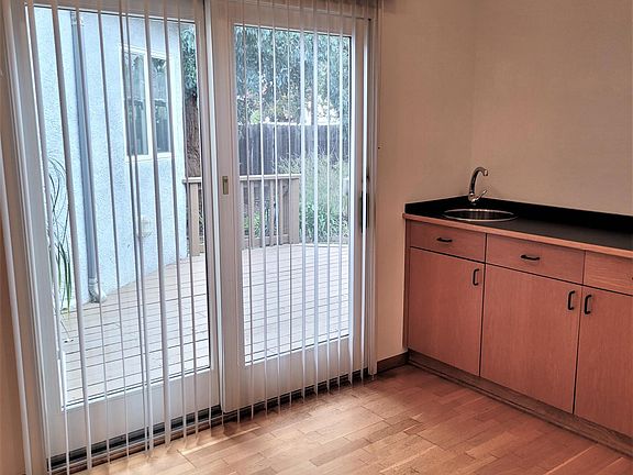 Wet bar is conveniently located near door to backyard for summer dining & entertaining