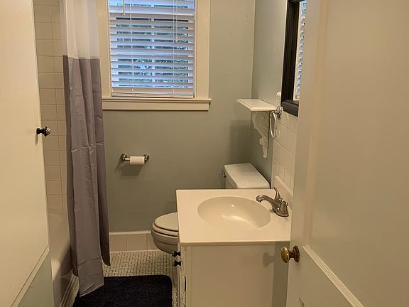 Beautiful Bathroom with original Cast Iron tub, fully tiled surround