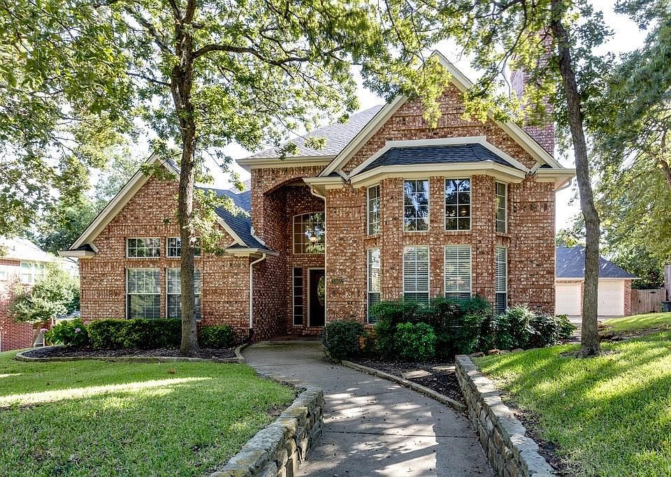 Stately brick home nestled on a .34 acre treed lot with a 3-car garage, a sparkling pool and lush landscaping.
