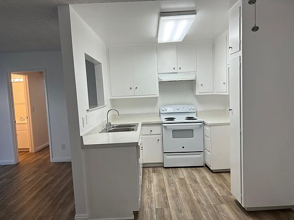 Looking toward kitchen and living room toward hallway. Guest bathroom on the left. (2x2)