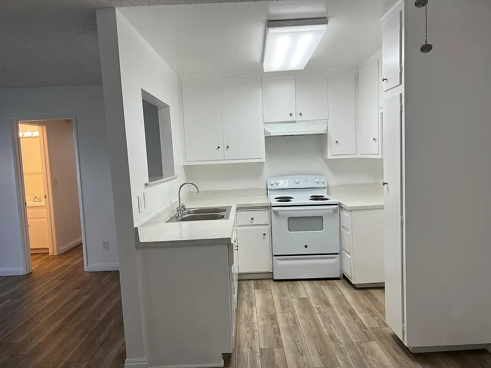 Looking toward kitchen and living room toward hallway. Guest bathroom on the left. (2x2)