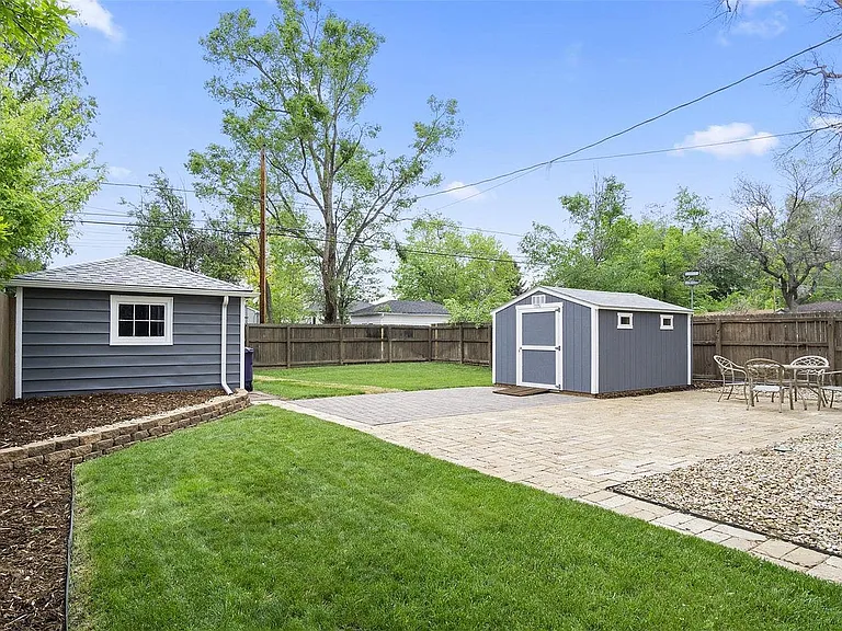 The large back patio is great having guests and the fenced in yard is ideal for dogs. There is also a separate side patio, which is where the entrance to the downstairs apartment is located. Yard is mowed by owner. Note: the garage and storage unit pic