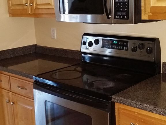 Open kitchen with eat in area and stainless steel appliances