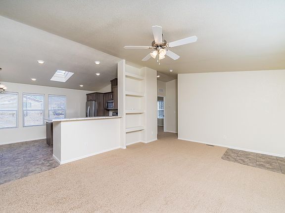 Very open & spacious "great room", kitchen, dining area, & living room.  Lots of windows!  Solid wood cabinets, vaulted ceilings, 2" faux wood blinds & upgraded lighting.