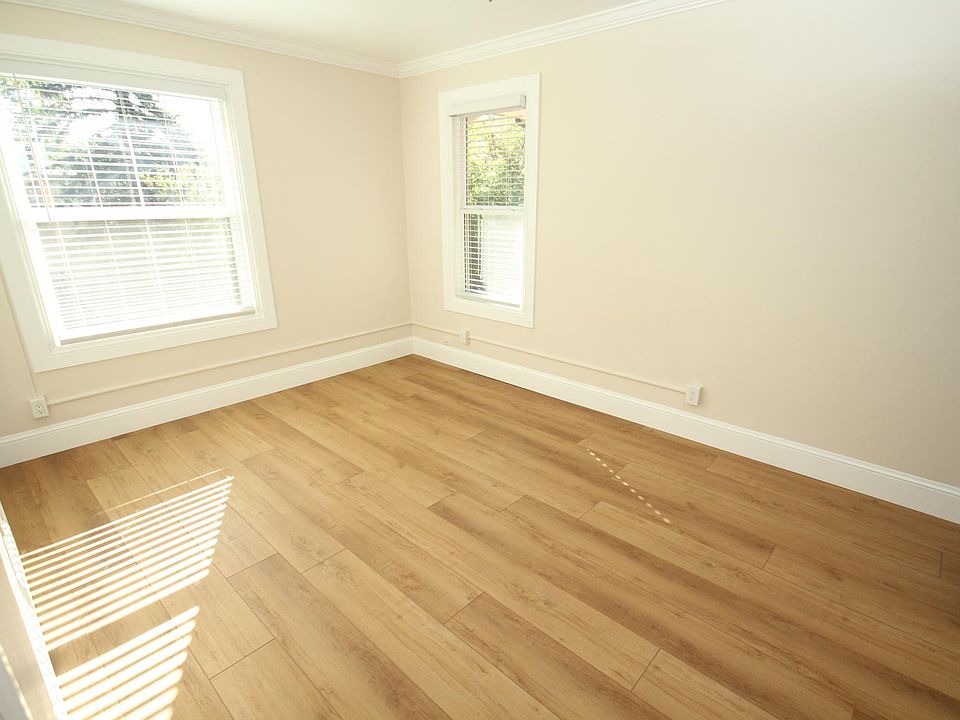 Living Room with new paint, new casing, new baseboards, new blinds, new flooring