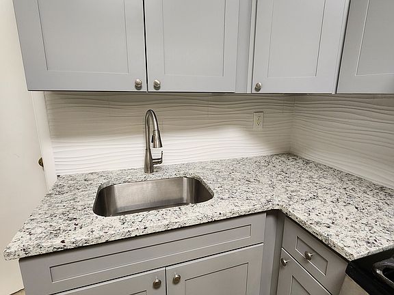 Brand new modern cabinetry and stone countertops.