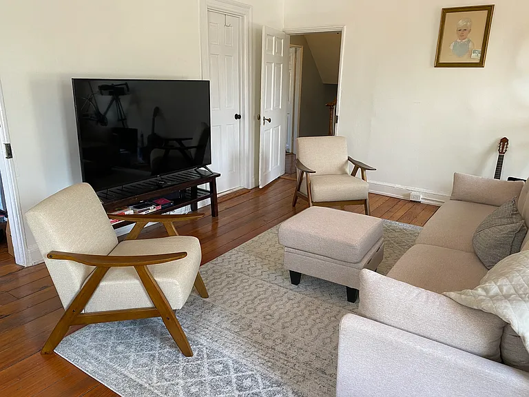 Large living room with new modern furnishings and TV