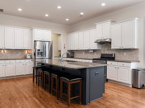 Beautiful Kitchen with Granite Countertops and Lights Under The Cabinets
