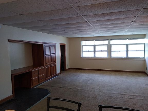 Large living room with entertainment and office cabinetry, will have new carpet