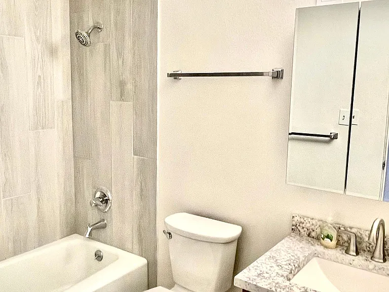 Newly up-dated bathroom with tub shower, stone counter top and sink