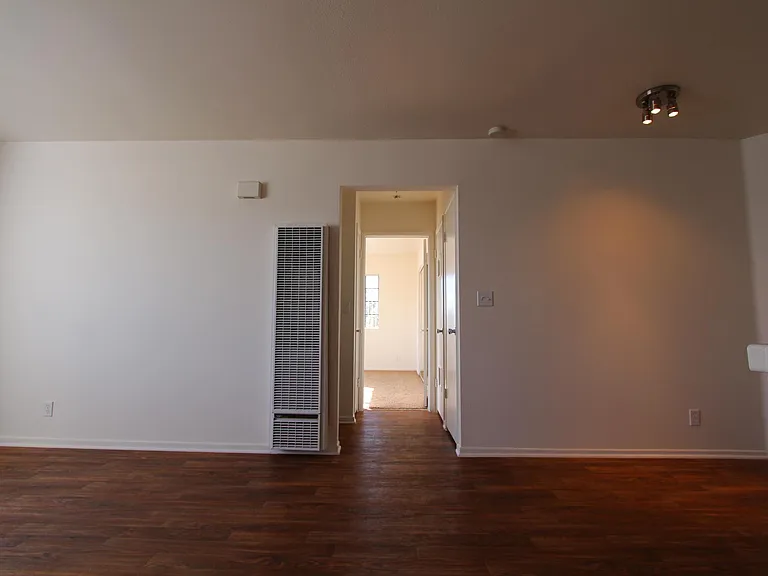 View from front door, down the hallway into the bedroom