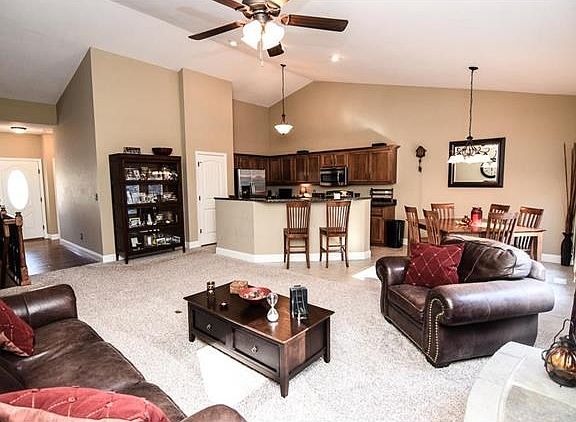 Open floor plan with faulted ceiling in this spacious living area.