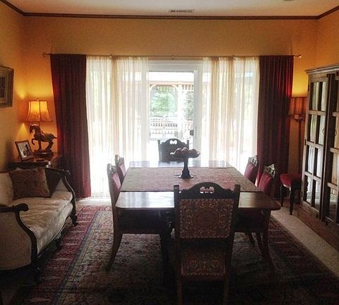 This formal living room that looks out onto the patio toward the gazebo is currently being used as a formal dining room.